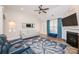 Cozy living room with plush seating, a fireplace, and a ceiling fan for ultimate relaxation at 9026 Raven Top Dr, Mint Hill, NC 28227