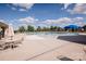 Large community pool with ample lounge chairs, sun umbrellas, and an inviting sunbathing area at 9026 Raven Top Dr, Mint Hill, NC 28227