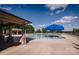 Expansive community pool area featuring ample seating, sun umbrellas, and a nearby covered pavilion at 9026 Raven Top Dr, Mint Hill, NC 28227