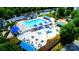 Aerial view of community pool featuring seating, blue umbrellas, and splash pad at 9614 Springholm Dr, Charlotte, NC 28278