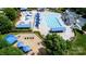 Aerial view showcasing a community pool, playground, and recreation area with shaded seating at 9614 Springholm Dr, Charlotte, NC 28278