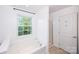 Bright bathroom features a soaking tub with large window and separate glass-door shower at 9614 Springholm Dr, Charlotte, NC 28278