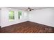Bright bedroom with natural light, hardwood floors, and ceiling fan at 9614 Springholm Dr, Charlotte, NC 28278