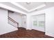 Bright entryway with hardwood floors, staircase, and natural light from the front window at 9614 Springholm Dr, Charlotte, NC 28278