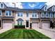 Charming townhome with a well-manicured lawn, attached garage, and stone accents at 9614 Springholm Dr, Charlotte, NC 28278
