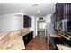Modern kitchen with granite countertops, stainless steel appliances, and dark cabinetry at 9614 Springholm Dr, Charlotte, NC 28278