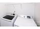 Laundry room featuring modern, front-loading washer and dryer set with storage shelf at 9614 Springholm Dr, Charlotte, NC 28278