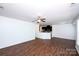 Open-concept living area with hardwood floors and a view into the modern kitchen at 9614 Springholm Dr, Charlotte, NC 28278