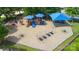 Aerial view of a well-equipped playground featuring slides, swings, and shaded areas at 9614 Springholm Dr, Charlotte, NC 28278