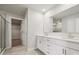 Bright bathroom featuring double vanity with modern fixtures, large mirror, and access to a walk-in closet at 9944 Manor Vista Trl, Kannapolis, NC 28027