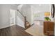 Inviting foyer features wood flooring, stairs with carpet runner, stylish console table, and access to other rooms at 9944 Manor Vista Trl, Kannapolis, NC 28027