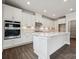 Modern kitchen features white cabinets, stainless steel appliances, and a large center island at 9944 Manor Vista Trl, Kannapolis, NC 28027