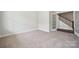 Bright and airy living room with plush carpeting, white trim, and French doors leading to other parts of the home at 9944 Manor Vista Trl, Kannapolis, NC 28027