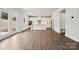 Expansive open-concept living space with wood-look floors leading into a bright kitchen at 9944 Manor Vista Trl, Kannapolis, NC 28027
