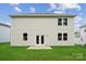 View of backyard featuring a two-story house, patio, and lush green lawn in a Gathering-friendly neighborhood at 9956 Manor Vista Trl, Kannapolis, NC 28027