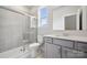 Clean and modern bathroom featuring a glass-enclosed shower, tile floors, and gray vanity with a white countertop at 9956 Manor Vista Trl, Kannapolis, NC 28027