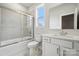 Well-lit bathroom featuring a shower-tub combo and a white vanity with storage at 9956 Manor Vista Trl, Kannapolis, NC 28027