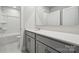 A bathroom featuring a toilet, tub, sink with a gray cabinet and a mirror at 9956 Manor Vista Trl, Kannapolis, NC 28027