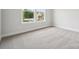 Bright bedroom with neutral carpeting, two windows, and baseboard trim at 9956 Manor Vista Trl, Kannapolis, NC 28027