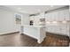 Bright kitchen with white cabinets, large center island, and modern stainless steel appliances at 9956 Manor Vista Trl, Kannapolis, NC 28027