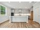 Bright kitchen featuring gray cabinets, white countertops, an island, and stainless steel appliances at 9956 Manor Vista Trl, Kannapolis, NC 28027