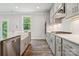 Well-lit kitchen featuring gray cabinets, white countertops, stainless steel appliances, and a farmhouse sink at 9956 Manor Vista Trl, Kannapolis, NC 28027