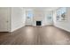 Bright living room with fireplace, large windows, and stylish hardwood floors at 9956 Manor Vista Trl, Kannapolis, NC 28027