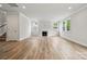 Spacious living room featuring wood-look floors, fireplace, and windows with natural light and recessed lighting at 9956 Manor Vista Trl, Kannapolis, NC 28027