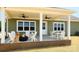Inviting covered back porch with ceiling fans, fire pit, and outdoor seating; perfect for entertaining at Lot 101 Coppergate Dr, Salisbury, NC 28147