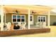 Cozy covered back porch featuring comfortable seating, a fire pit, ceiling fans and views of the backyard at Lot 101 Coppergate Dr, Salisbury, NC 28147