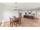 Open-concept dining area with kitchen island, modern lighting, and ample space for entertaining at Lot 101 Coppergate Dr, Salisbury, NC 28147