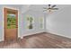 A versatile, empty room with hardwood floors, a ceiling fan, natural light, and a view of the outdoors at Lot 101 Coppergate Dr, Salisbury, NC 28147