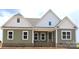 New construction featuring a charming exterior with a mix of brick and vertical siding and a covered porch at Lot 101 Coppergate Dr, Salisbury, NC 28147