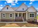 Charming home showcasing a welcoming front porch with brick accents and well-maintained landscaping at Lot 101 Coppergate Dr, Salisbury, NC 28147