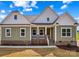 Charming home with a welcoming front porch, manicured landscaping, and a combination of siding and brick accents at Lot 101 Coppergate Dr, Salisbury, NC 28147