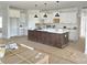Spacious kitchen featuring white cabinets, a large island, and modern pendant lighting at Lot 101 Coppergate Dr, Salisbury, NC 28147