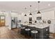 Modern kitchen with white cabinets, stainless appliances, island with seating, and pendant lights at Lot 101 Coppergate Dr, Salisbury, NC 28147