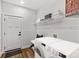 Modern laundry room with front load washer and dryer, shelf storage, and stylish flooring at Lot 101 Coppergate Dr, Salisbury, NC 28147