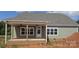 Home's rear exterior with covered patio and ceiling fans, perfect for outdoor relaxation at Lot 101 Coppergate Dr, Salisbury, NC 28147