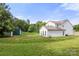 Large grassy backyard with a storage shed at 100 Brookstone Dr, Mount Holly, NC 28120