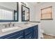 Bathroom with double vanity with framed mirrors and warm wood blinds at 100 Brookstone Dr, Mount Holly, NC 28120