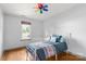 Cozy bedroom with a decorative bed, a bright window, and wood-look flooring at 100 Brookstone Dr, Mount Holly, NC 28120