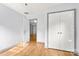 Light and airy bedroom features hardwood floors, a closet, and a doorway leading to another room at 100 Brookstone Dr, Mount Holly, NC 28120