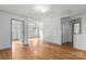 Spacious open bonus room showcasing hardwood floors and natural lighting from several windows at 100 Brookstone Dr, Mount Holly, NC 28120