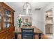 A dining room showcases a wooden table and chairs alongside a classic wooden china cabinet with views to the living room at 100 Brookstone Dr, Mount Holly, NC 28120