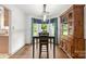 Bright dining room highlighting wood flooring, modern lighting, and cabinet at 100 Brookstone Dr, Mount Holly, NC 28120