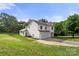 Traditional two-story house with an attached garage and a large front yard at 100 Brookstone Dr, Mount Holly, NC 28120