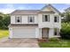 Charming two-story home with a two car garage, neutral siding, and well manicured landscaping at 100 Brookstone Dr, Mount Holly, NC 28120