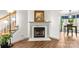 Cozy room highlighting a fireplace with wood flooring, a plant, and eating space nearby at 100 Brookstone Dr, Mount Holly, NC 28120