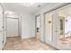 Bright hallway with tile floors and multiple closets, leading to a doorway that offers access to an outdoor patio at 100 Brookstone Dr, Mount Holly, NC 28120